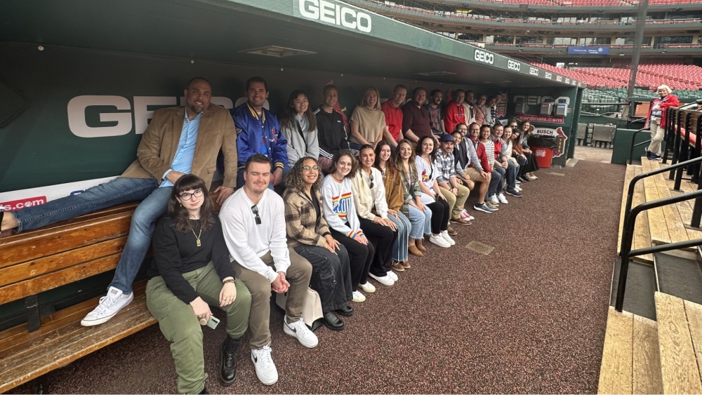 Team members in a baseball dugout.