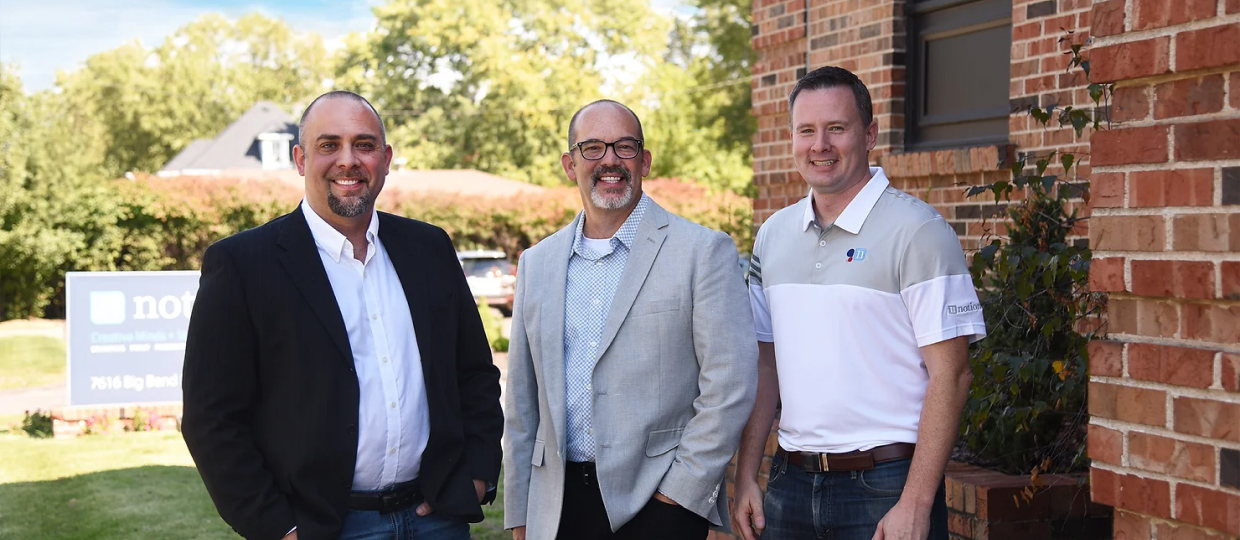 Louis, John, and Matt standing in front of the Notion office.