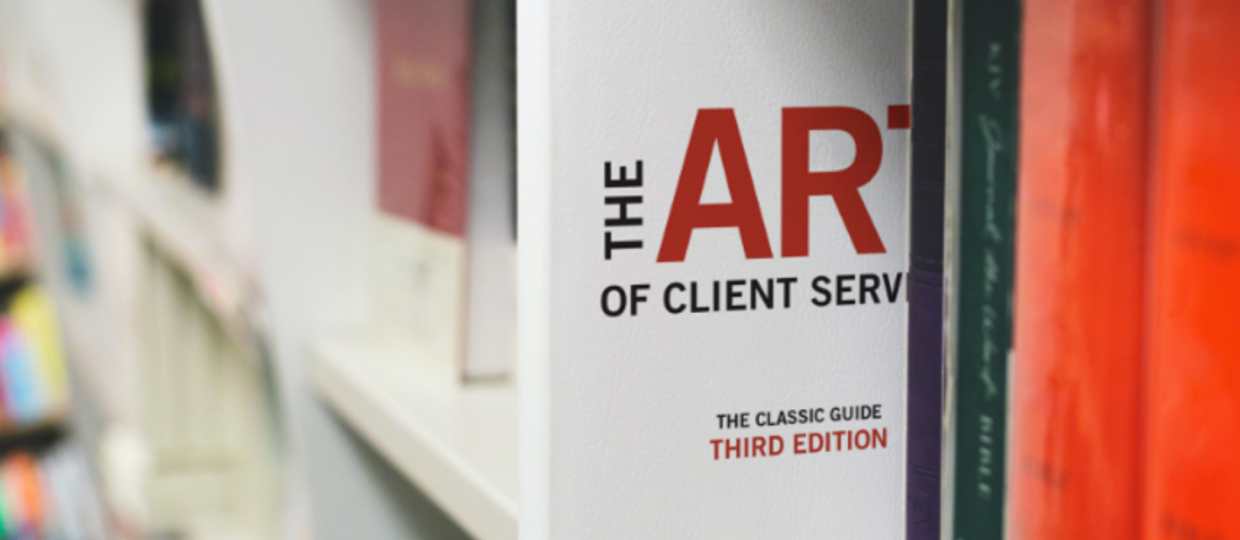 Book on a shelf: The Art of Client Service.