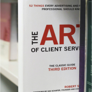 Book on a shelf: The Art of Client Service.