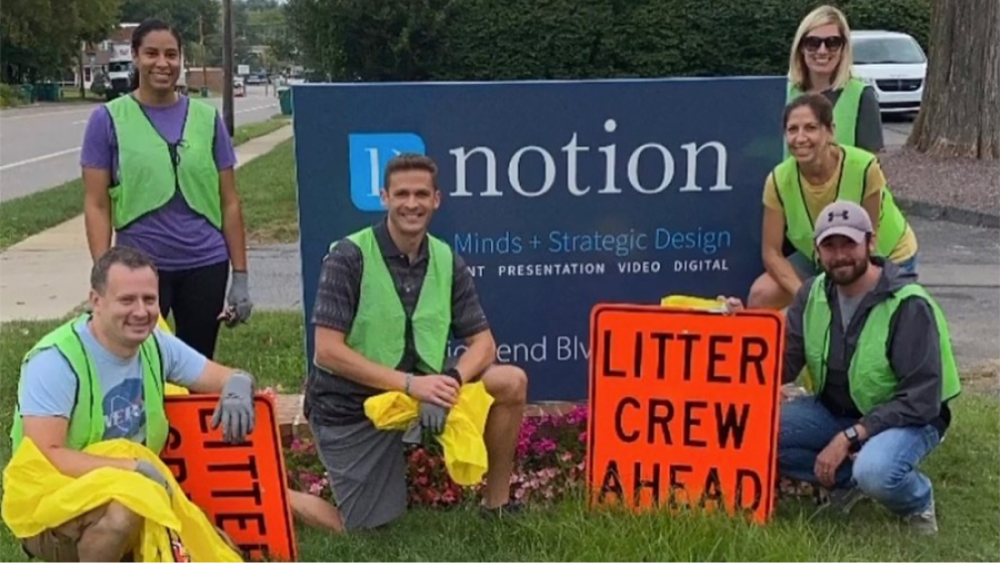 Team members participating in a litter cleanup crew.