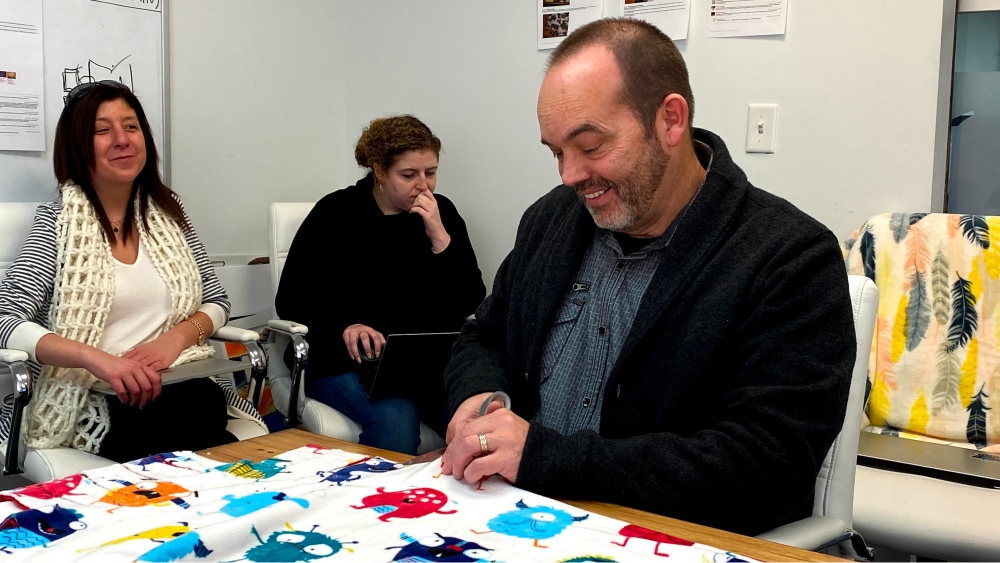 John cutting fabric.