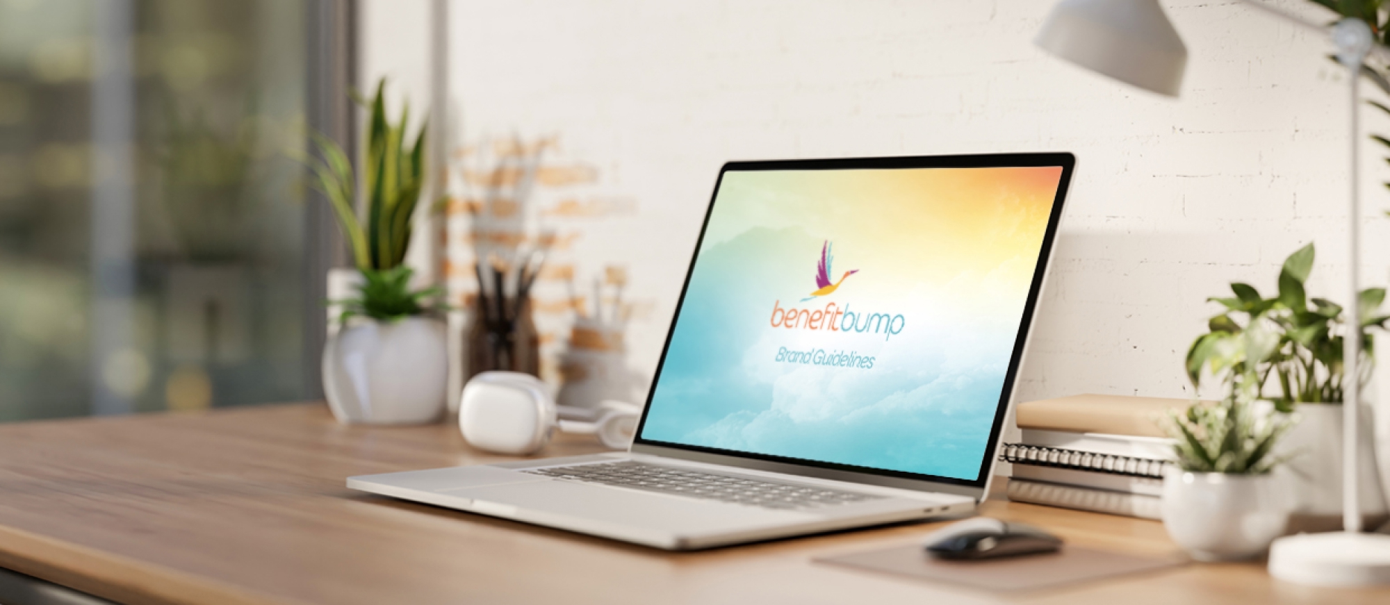 Laptop showing BenefitBump brand guidelines.